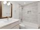 Bathroom featuring large vanity with dark wood mirror frame, bath tub, and patterned tile at 6075 S Filbert Ct, Centennial, CO 80121