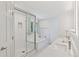Bright primary bathroom with double sinks, shower, tub, and a large window at 6075 S Filbert Ct, Centennial, CO 80121