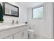 Bright bathroom with double vanity, modern fixtures, and stylish patterned tile flooring at 6075 S Filbert Ct, Centennial, CO 80121