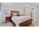 Bright bedroom features a wood bed frame, white walls, and matching nightstands with decorative lamps at 6075 S Filbert Ct, Centennial, CO 80121