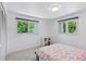 Bedroom with two windows, white walls, a white closet, and a bed with colorful sheets at 6075 S Filbert Ct, Centennial, CO 80121
