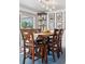 Bright dining room featuring wood table, X-back chairs, modern lighting, and sliding glass doors at 6075 S Filbert Ct, Centennial, CO 80121