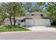 Charming home featuring mature trees, green lawn, and a spacious three-car garage at 6075 S Filbert Ct, Centennial, CO 80121