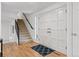 Bright foyer features hardwood floors, staircase with rod iron railing, and double entry doors at 6075 S Filbert Ct, Centennial, CO 80121