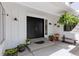 Inviting front porch with double doors, decorative plants, and cozy seating at 6075 S Filbert Ct, Centennial, CO 80121