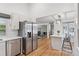 Spacious kitchen with stainless steel appliances, white cabinetry, and an open layout leading to the living area at 6075 S Filbert Ct, Centennial, CO 80121