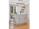 Modern kitchen island features a gray cabinet base, sleek hardware, and stylish pendant lighting at 6075 S Filbert Ct, Centennial, CO 80121