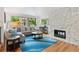 Bright living room with stone fireplace, hardwood floors, and large windows at 6075 S Filbert Ct, Centennial, CO 80121