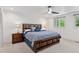 Comfortable primary bedroom featuring a wood bed frame, ceiling fan, and natural light at 6075 S Filbert Ct, Centennial, CO 80121
