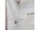 Bright bathroom featuring a shower stall with new fixtures and white marble-look tile at 6075 S Filbert Ct, Centennial, CO 80121