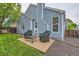 Backyard patio, lush lawn, privacy fence, and light blue siding creates a serene outdoor retreat at 12060 N Holly Way, Brighton, CO 80602