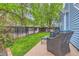 Outdoor patio with wicker furniture, surrounded by a lush lawn and privacy fence, perfect for entertaining at 12060 N Holly Way, Brighton, CO 80602