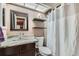Cozy bathroom featuring tiled shower/tub and modern fixtures, vanity with granite countertops at 12060 N Holly Way, Brighton, CO 80602