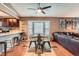 Open concept dining area with access to the kitchen and view of the living room and sofa at 12060 N Holly Way, Brighton, CO 80602