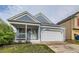 Charming home with light-blue siding, porch, well-maintained lawn, and an attached two car garage at 12060 N Holly Way, Brighton, CO 80602