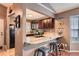 Modern kitchen with granite countertops, dark wood cabinetry, and stainless steel appliances at 12060 N Holly Way, Brighton, CO 80602