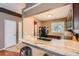 Well-lit kitchen featuring granite countertops, stainless steel appliances, and a view of the dining area at 12060 N Holly Way, Brighton, CO 80602