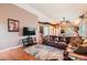 Cozy living room with a large leather sofa, entertainment center, and hardwood floors at 12060 N Holly Way, Brighton, CO 80602