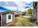 View of a backyard with a shed, patio, and well-manicured lawn, offering space for gardening and outdoor activities at 20305 E 41St Ave, Denver, CO 80249