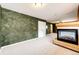 Finished basement features a modern fireplace, accent wall paint, and ample room for activities at 20305 E 41St Ave, Denver, CO 80249