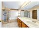 Bright bathroom with double sinks, a glass-enclosed shower, and a soaking tub for relaxation at 20305 E 41St Ave, Denver, CO 80249