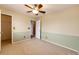 Bright bedroom with a ceiling fan, neutral carpet, and natural light from the window at 20305 E 41St Ave, Denver, CO 80249