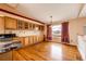 Bright dining area featuring hardwood floors, cabinet storage, and a large window with picturesque views at 20305 E 41St Ave, Denver, CO 80249