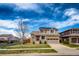 Charming two-story house with a stone facade, a well-manicured lawn, and a paved driveway at 20305 E 41St Ave, Denver, CO 80249