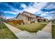 Corner lot property with a well-kept lawn, a wood fence, and a two-car garage at 20305 E 41St Ave, Denver, CO 80249