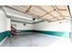 Garage with Epoxy flooring, painted walls, and overhead storage, offering ample space at 20305 E 41St Ave, Denver, CO 80249