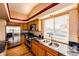 Bright kitchen featuring granite countertops, stainless steel appliances, and a large window for natural light at 20305 E 41St Ave, Denver, CO 80249