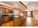 Modern kitchen featuring hardwood floors, an island, and stainless steel appliances for gourmet cooking at 20305 E 41St Ave, Denver, CO 80249