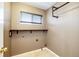 Well-lit laundry room featuring durable tile floors and ample storage space with a convenient hanging rack at 20305 E 41St Ave, Denver, CO 80249
