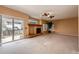 Bright living room featuring a fireplace, sliding glass doors, and a decorative stained glass window above the mantel at 20305 E 41St Ave, Denver, CO 80249