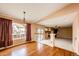 Open-concept living room with hardwood floors, a fireplace, and large windows offering plenty of natural light at 20305 E 41St Ave, Denver, CO 80249