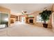 Open-concept living room featuring a fireplace, sliding glass doors, and staircase access to the upper level at 20305 E 41St Ave, Denver, CO 80249