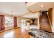 Open-concept living room with hardwood floors and staircase to upstairs loft, perfect for modern living at 20305 E 41St Ave, Denver, CO 80249