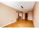 Spacious living room featuring gleaming hardwood floors and neutral-toned walls with contemporary lighting at 20305 E 41St Ave, Denver, CO 80249