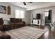 Living room features a brown sectional sofa and a large area rug at 360 S 30Th Ave, Brighton, CO 80601