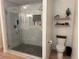 Updated bathroom with glass shower, dual shower heads, white marble tile and decorative shelves at 1786 Quartz St, Castle Rock, CO 80109