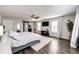 Spacious main bedroom featuring wood floors, a ceiling fan, large windows, and a barn door to the en suite bathroom at 1786 Quartz St, Castle Rock, CO 80109