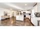 Bright kitchen with stainless appliances, granite counters, and wood floors at 1786 Quartz St, Castle Rock, CO 80109