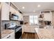 Updated kitchen featuring granite countertops and white cabinetry at 1786 Quartz St, Castle Rock, CO 80109