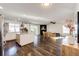 Open-concept kitchen and living area with fireplace, wood floors and sliding doors at 1786 Quartz St, Castle Rock, CO 80109