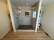 Contemporary glass enclosed shower features double shower heads, a marble tile surround, and black hexagon tile floor at 1786 Quartz St, Castle Rock, CO 80109