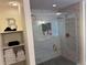 Modern shower with marble tiling, dual shower heads, and glass door; storage shelves beside the shower at 1786 Quartz St, Castle Rock, CO 80109