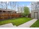 Well-maintained backyard with a lawn and a wooden fence providing privacy at 3028 N Gilpin St, Denver, CO 80205