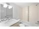 Well-lit bathroom featuring a vanity with mosaic tile trim and shower over tub at 3028 N Gilpin St, Denver, CO 80205