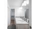 Modern bathroom featuring double sinks, a mosaic backsplash, and a door leading to the walk-in closet at 3028 N Gilpin St, Denver, CO 80205