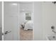 Bathroom view into a bedroom with bright, natural light and neutral walls at 3028 N Gilpin St, Denver, CO 80205